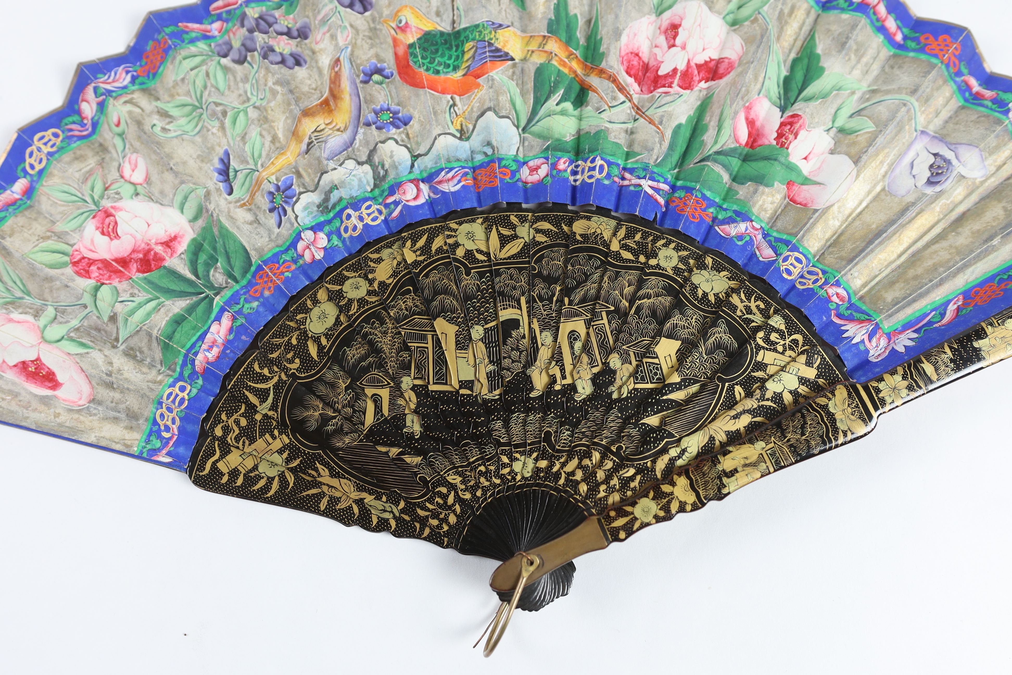 A 19th century Chinese ornately lacquered and hand painted figural leaf fan, the figures on the leaf having painted ivory faces, the back of the fan painted with exotic birds and flowers, CITES Submission reference TJUZX